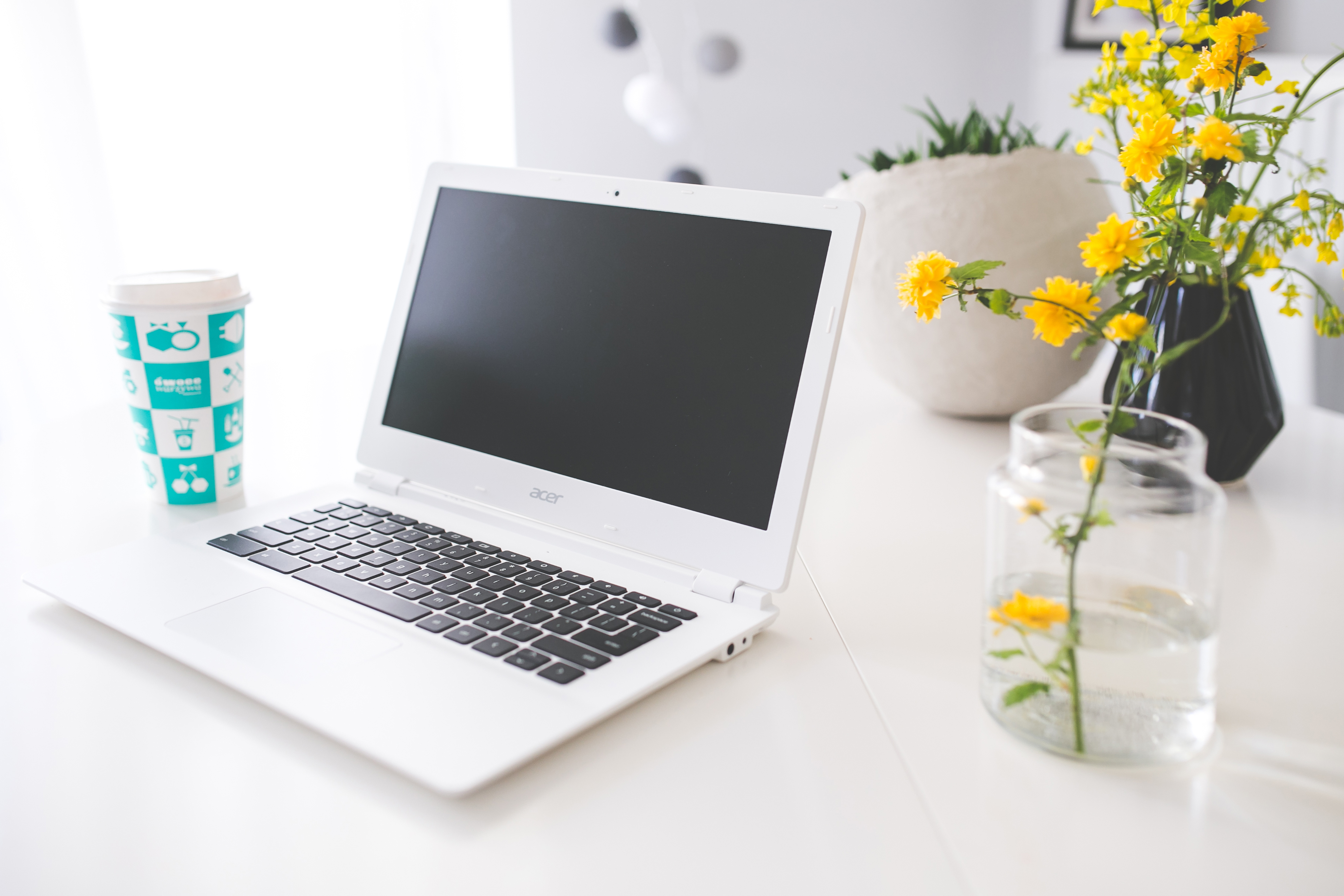 Openly licensed image of a bright desk with laptop and notebook